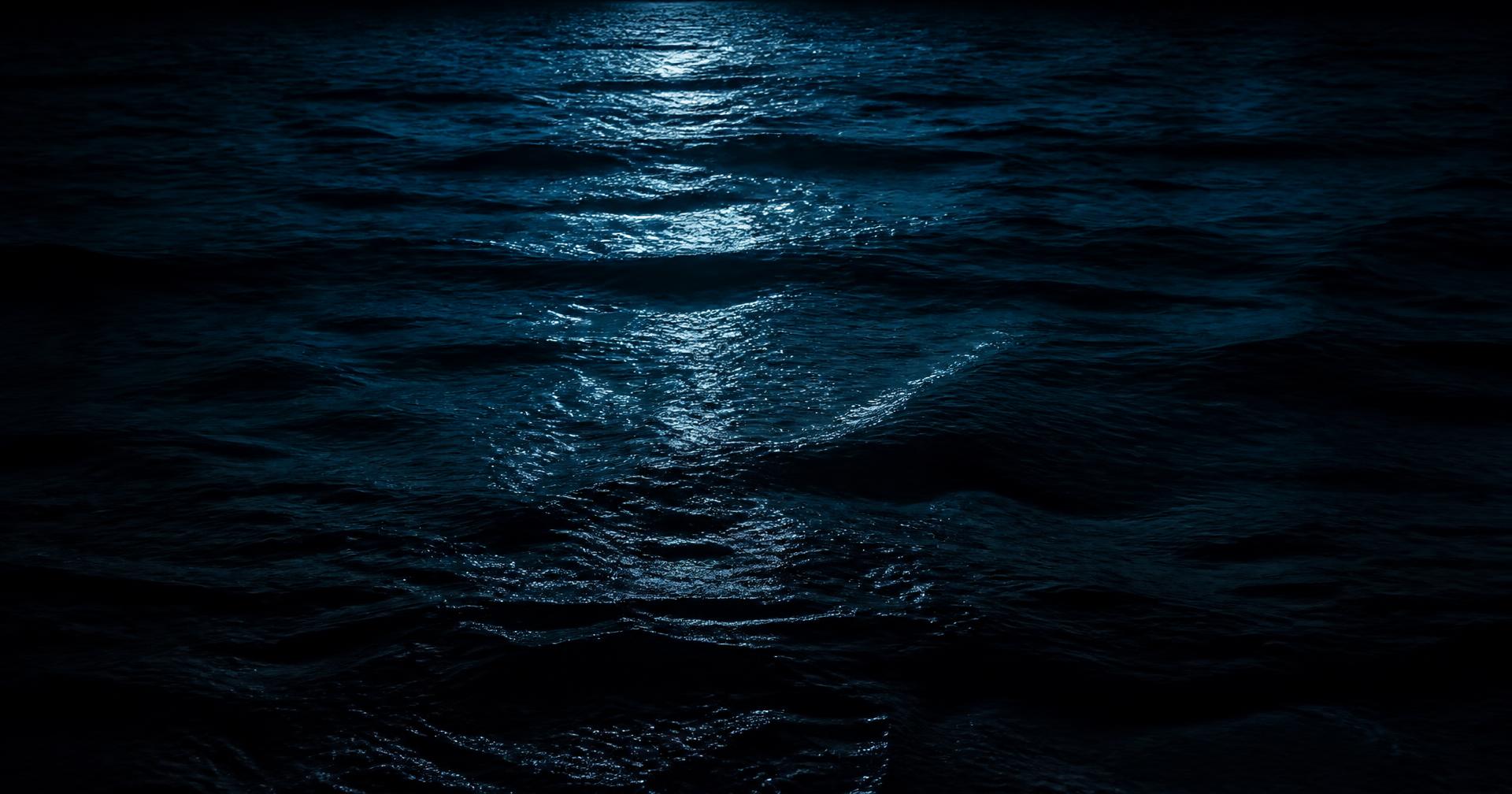 Moonlit dark ocean surface